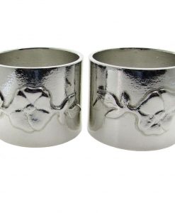 A pair of wild rose motif napkin rings cast in Cornish tin