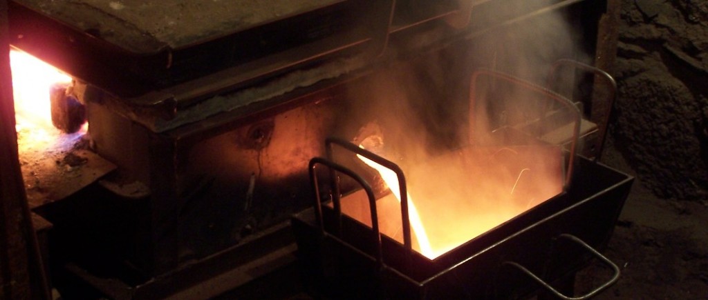 Tapping metal from our tin smelting furnace