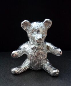 Sitting teddy cast in Cornish tin