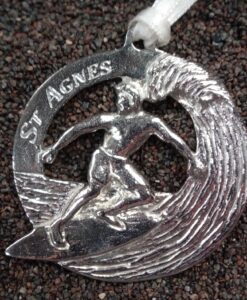 Surfer on a wave cast in Cornish tin