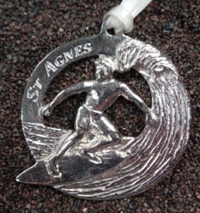 Surfer on a wave cast in Cornish tin